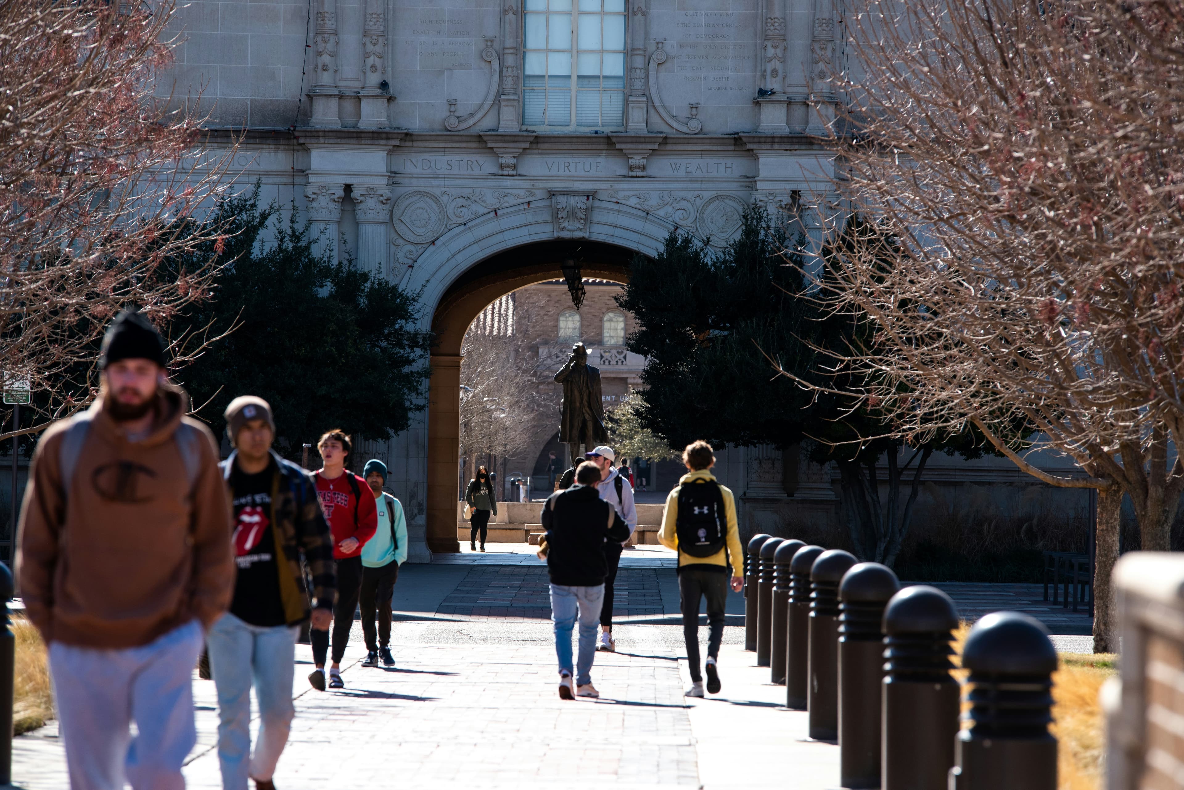Students walking through a campus archway