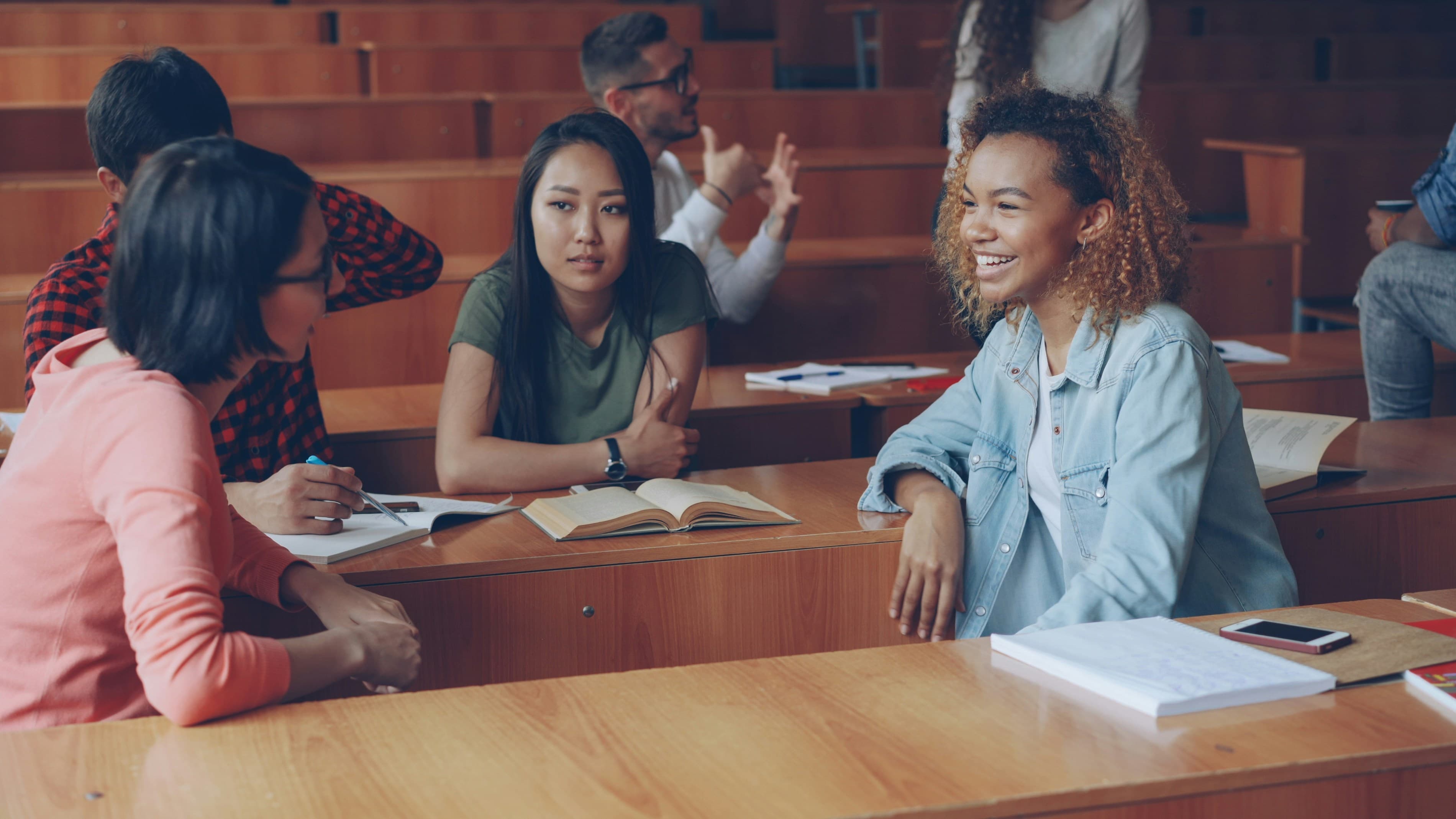 Students discussing their work around a classroom table